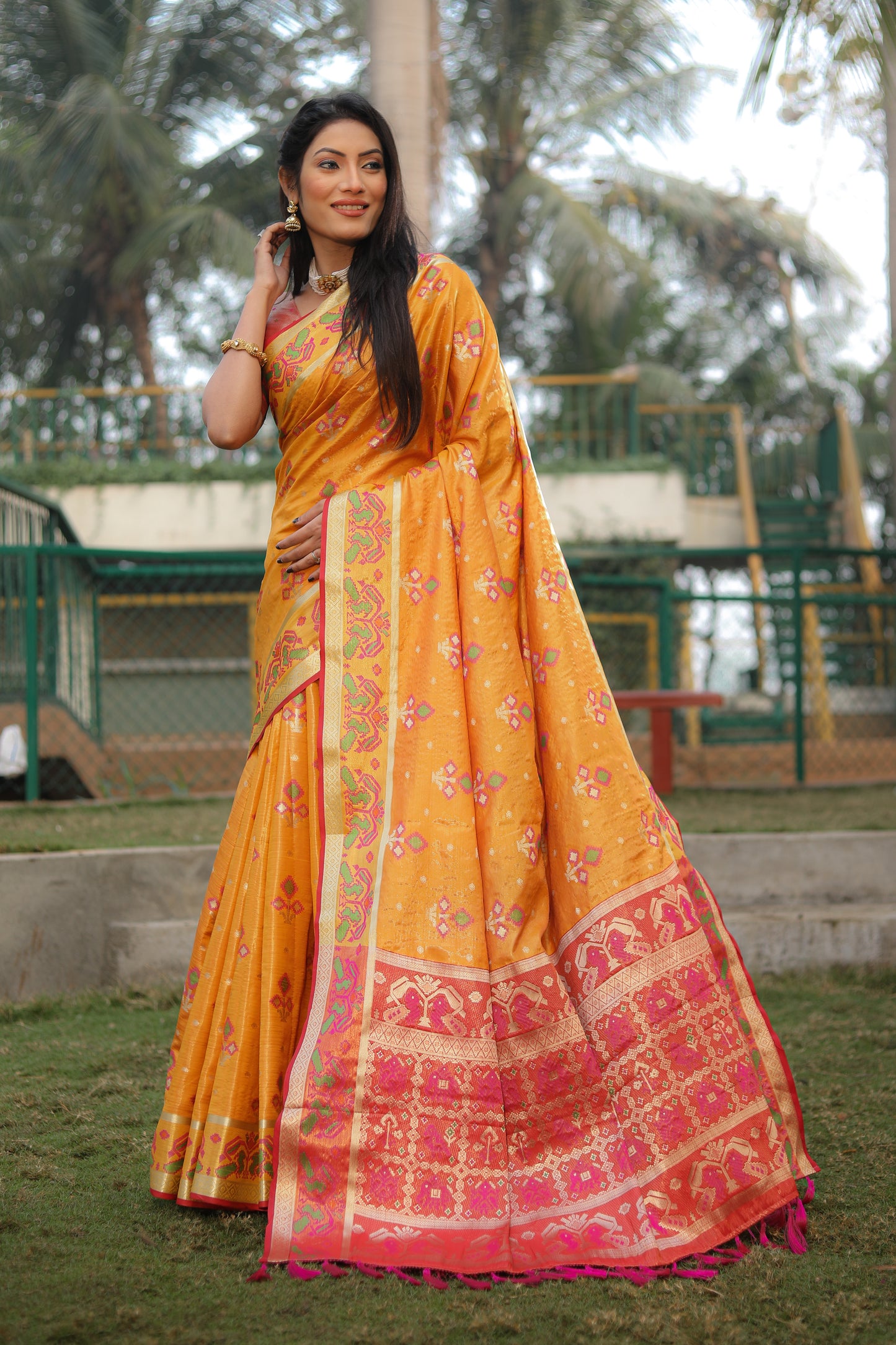 Yellow Isha Organza sarees with Ikkat Patola weave pallu with tassels