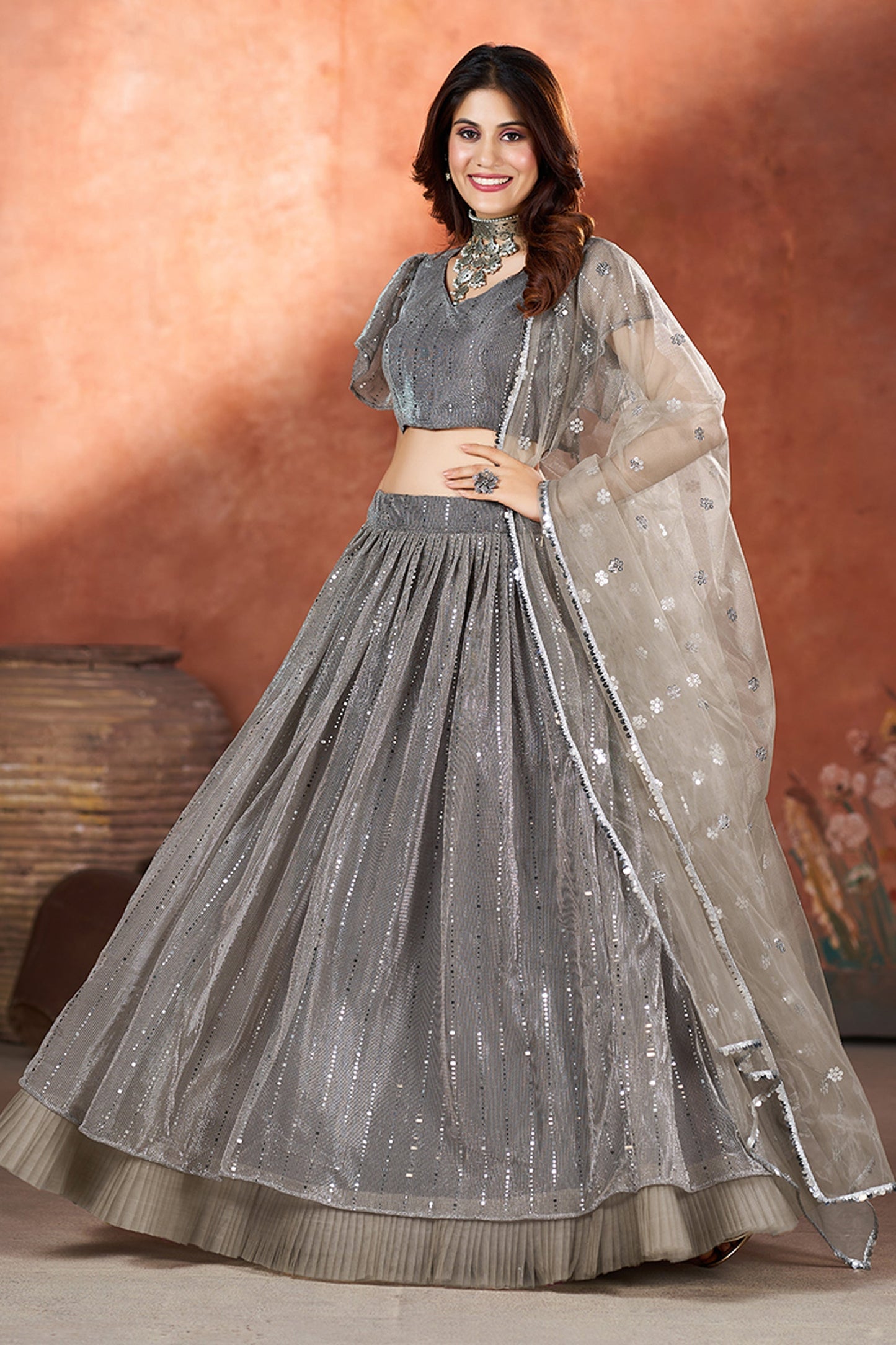 रेडिएंट नेट फ़ैब्रिक ग्रे कलर फंक्शन वियर सेक्विन वर्क लहंगा
