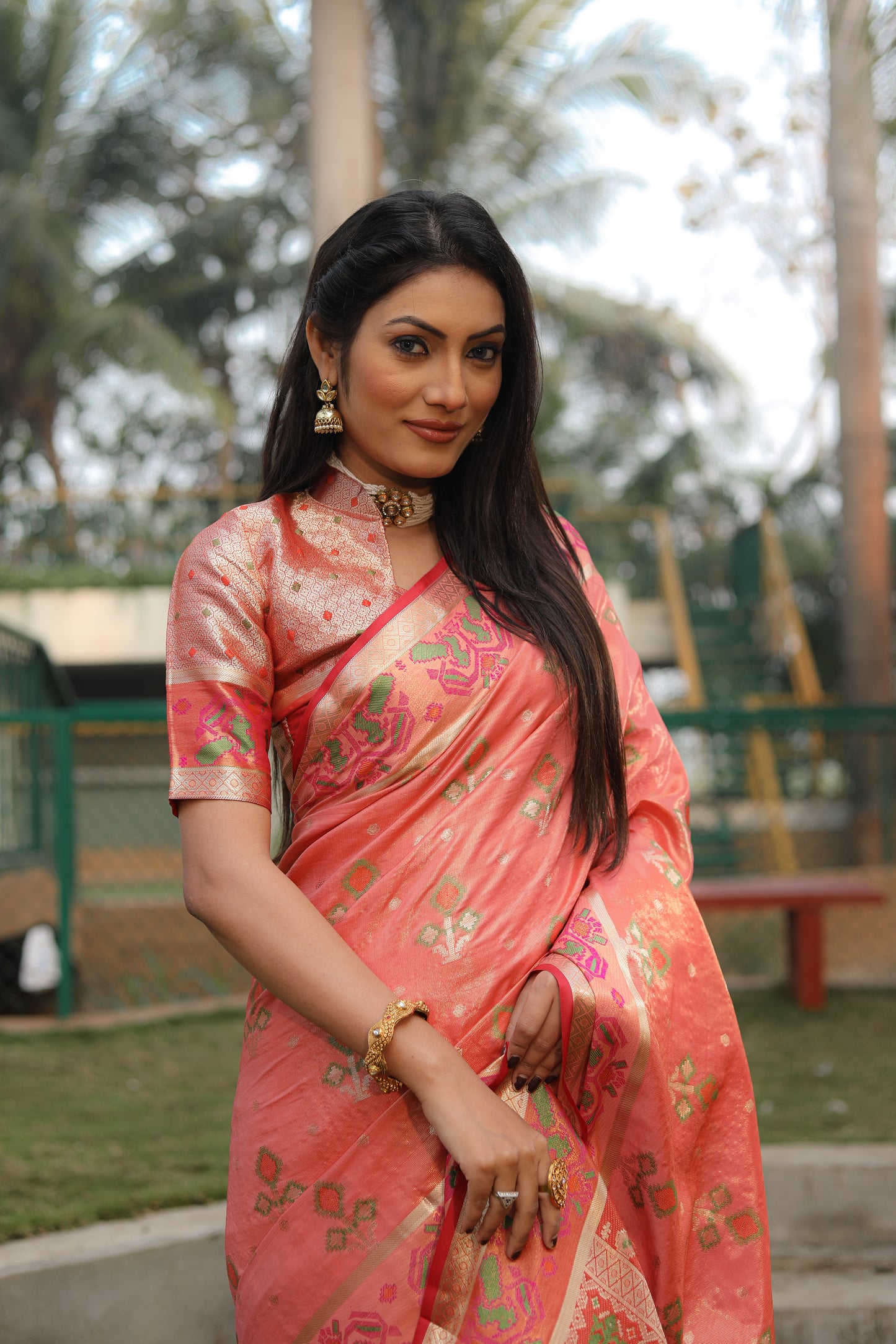 Peach Isha Organza sarees with Ikkat Patola weave pallu with tassels