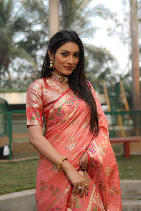 Peach Isha Organza sarees with Ikkat Patola weave pallu with tassels