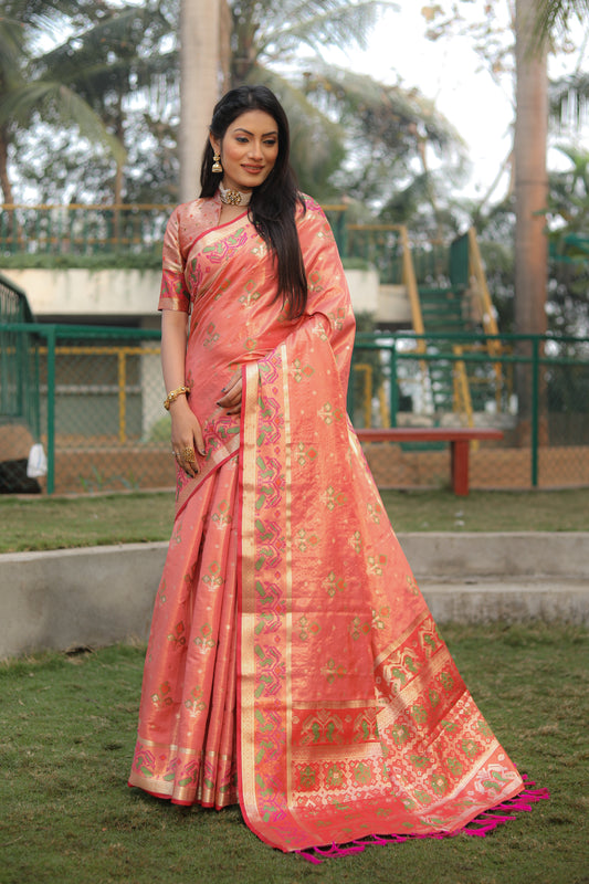 Peach Isha Organza sarees with Ikkat Patola weave pallu with tassels